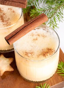 traditional homemade christmas drink eggnog glasses holiday drink wooden board white