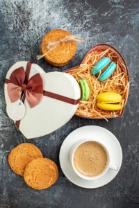 vertical view gift box with macarons cookies cup coffee icy dark background